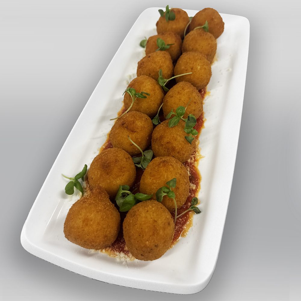 Arancini au ragù Arancini di riso au ragù, boules dorées et croustillantes servies sur sauce tomate au basilic